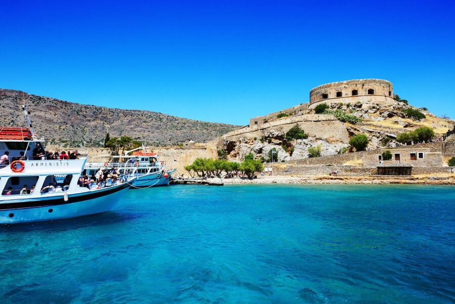 Elounda: Spinalonga Guided Boat Tour with BBQ and Swimming - Setting out from Elounda and crossing Mirabello Bay