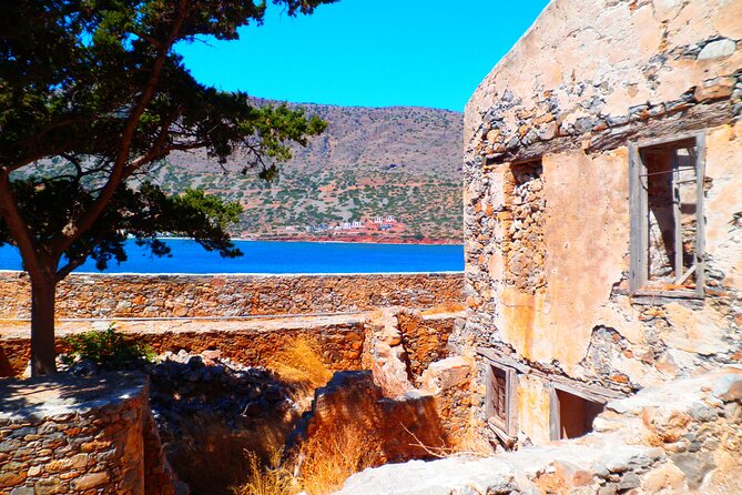 Elounda: Spinalonga Prof. Guided Boat Tour w/ BBQ + Swimming - Walking through Spinalonga’s many pasts